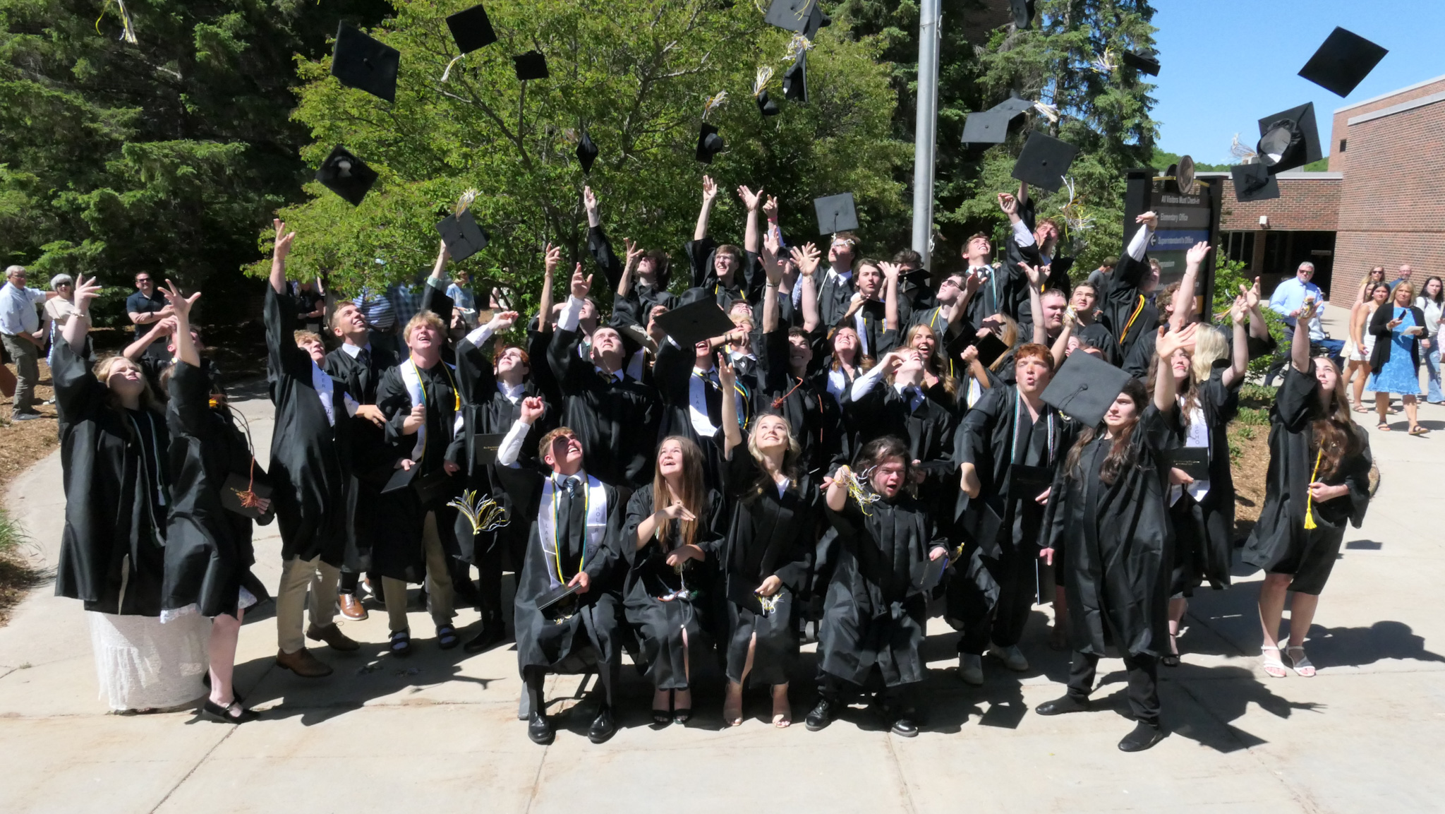 graduates tossing their caps
